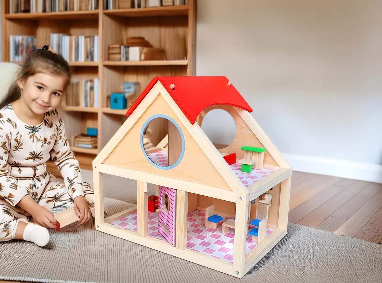A kid is playing with wooden doll house.